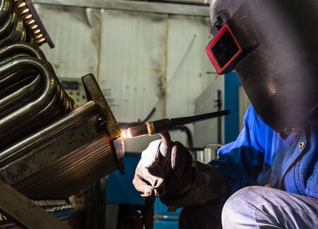 sparks while welder uses torch to welding