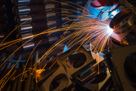 sparks while welder uses torch to weldingの写真素材