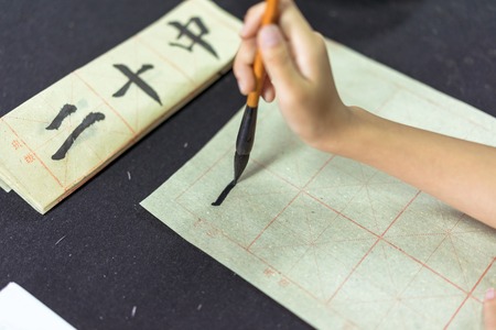 Chinese children learn to write Chinese characters, calligraphy is the traditional culture of Chinaの写真素材