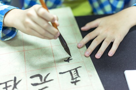 Chinese children learn to write Chinese characters, calligraphy is the traditional culture of Chinaの写真素材