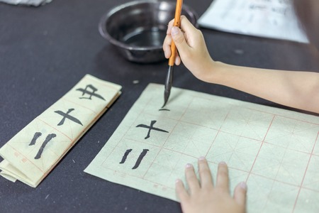 Chinese children learn to write Chinese characters, calligraphy is the traditional culture of Chinaの写真素材