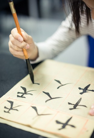 Chinese children learn to write Chinese characters, calligraphy is the traditional culture of Chinaの写真素材