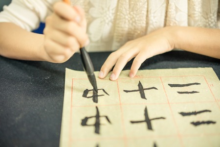 Chinese children learn to write Chinese characters, calligraphy is the traditional culture of Chinaの写真素材
