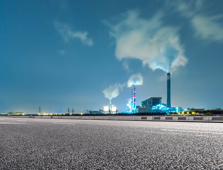 Wide angle landscape photograph of a road leading to a power plantのeditorial素材