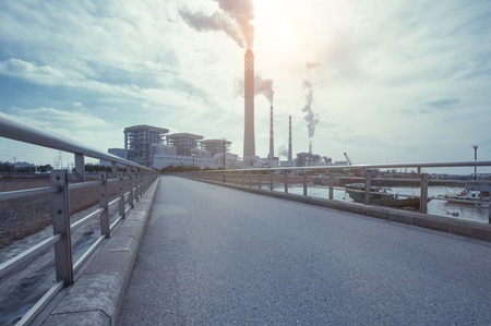 Wide angle landscape photograph of a road leading to a power plantのeditorial素材