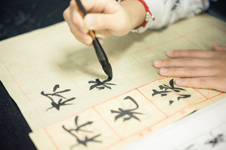 Chinese children learn to write Chinese characters, calligraphy is the traditional culture of Chinaの写真素材