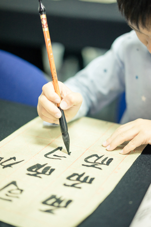 Chinese children learn to write Chinese characters, calligraphy is the traditional culture of Chinaの写真素材