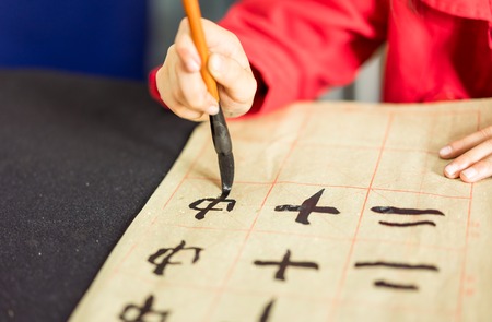Chinese children learn to write Chinese characters, calligraphy is the traditional culture of Chinaの写真素材