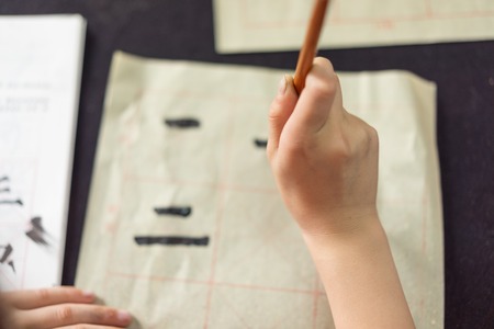 Chinese children learn to write Chinese characters, calligraphy is the traditional culture of Chinaの写真素材