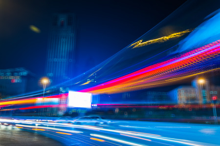 blurred traffic lights on road in central district at night.の写真素材
