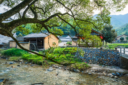 stream flowing through small village in China.の写真素材