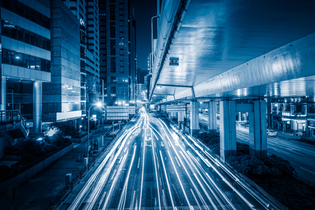 City view at night with traffic and trail light in blue tone.のeditorial素材