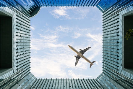 a shot of an airplane passing by of the buildings.のeditorial素材