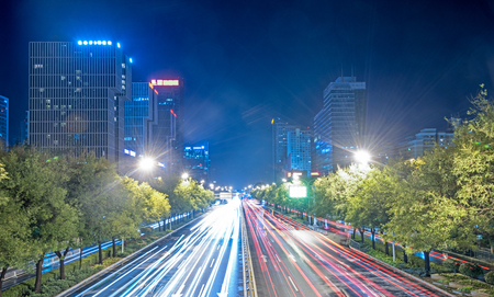 blurred traffic light trails on road at night in China.の写真素材