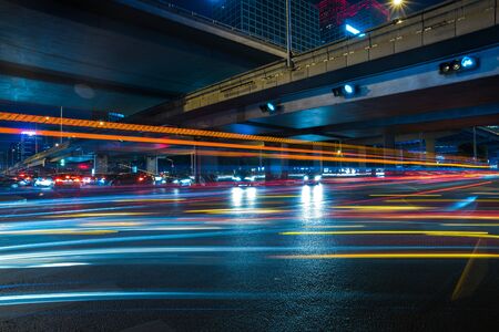 blurred traffic light trails on road at night in China.の写真素材