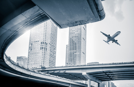 blurred street scene in city with a plane flying over in city of China.のeditorial素材