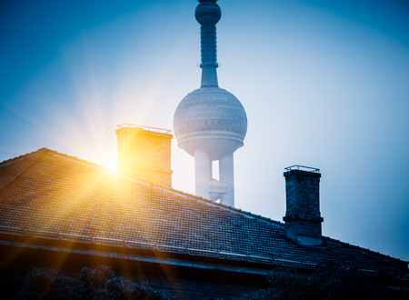 vintage house with part of oriental pearl tower in background,city skyline in China.のeditorial素材