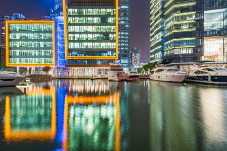 buildings standing by riverside under dramatic sky in Nanchang,China.