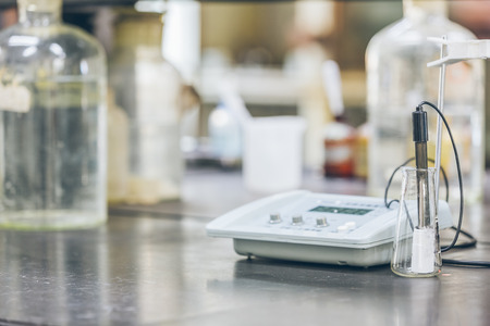 detail shot of beakers and equipment on table in factory laboratory.の写真素材