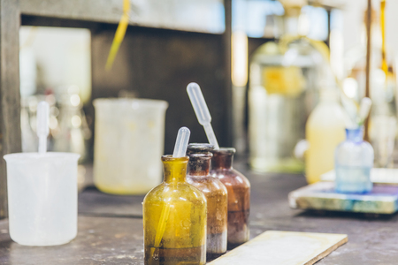 detail shot of beakers and equipment on table in factory laboratory.の写真素材