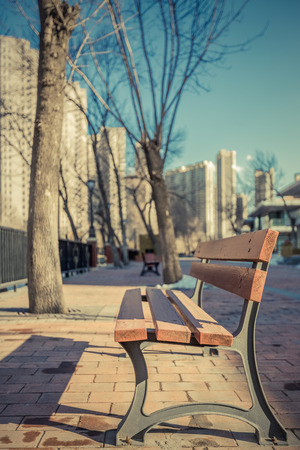 empty bench on pavement in city of China.の写真素材
