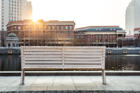 empty bench on pavement in city of China.の写真素材