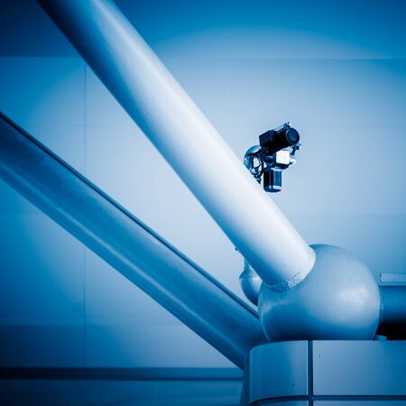 CCTV security camera on building constructure in blue tone.の写真素材