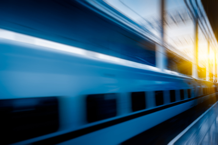 Blurred view of train leaving platform in city of China.