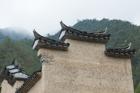 roof of historic building against green mountain,shot in Lishui,China.の写真素材