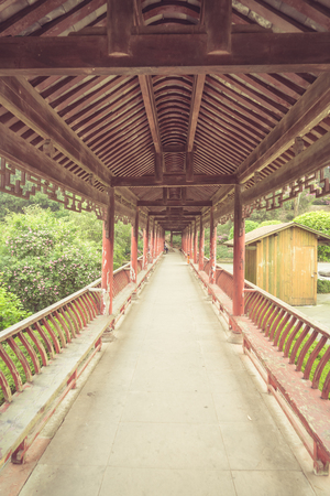 long corridor of Chinese traditional architecture in a park,shot in city of China.の写真素材