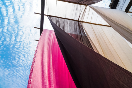 colorful fabric hanging to dry after traditional dye process,shot in Heng Dian Town,Zhejiang...