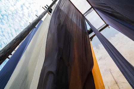 colorful fabric hanging to dry after traditional dye process,shot in Heng Dian Town,Zhejiang province of China.の写真素材