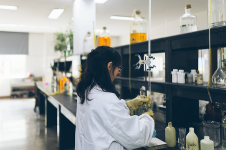 detail shot of beakers and equipment on table in factory laboratory.のeditorial素材