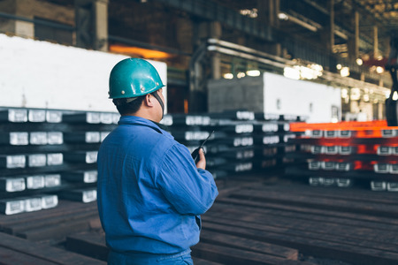 Photo pour worker using walkie-talkie in a metal factory,industry zone. - image libre de droit