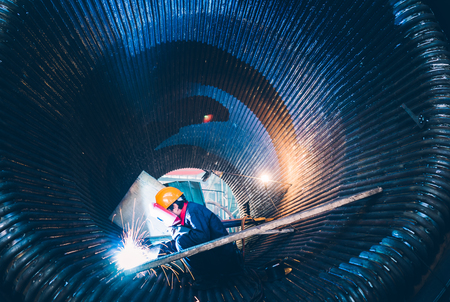 Worker doing electric welding,factory manufacturing,industry concepts.