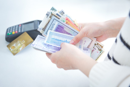cash and card payment with chip and pin machine in shop.の写真素材