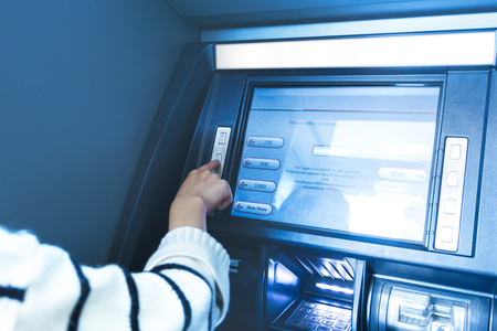 Woman using cash machine-ATM,close up view.の写真素材