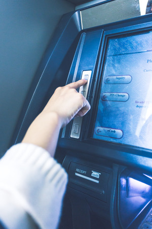 Woman using cash machine-ATM,close up view.の写真素材