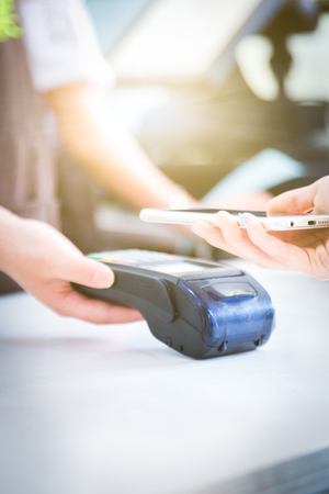 Close up of mobile payment in a shop.の写真素材