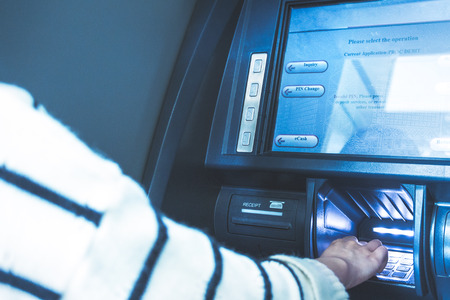 Woman using cash machine-ATM,close up view.の写真素材