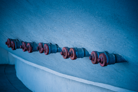 Red Valves In Row On Wall,in blue tone.の写真素材