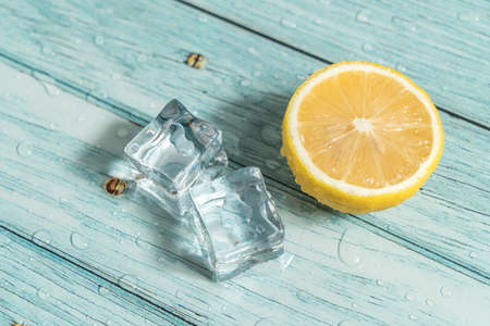 Lemon and ice on the blue tableの写真素材