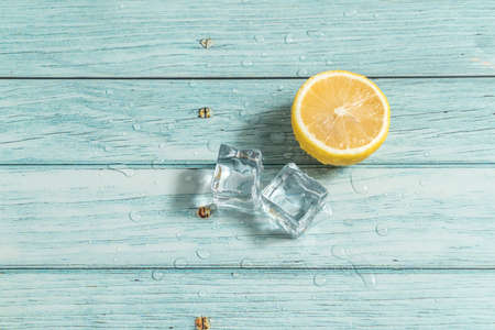 Lemon and ice on  the blue tableの写真素材
