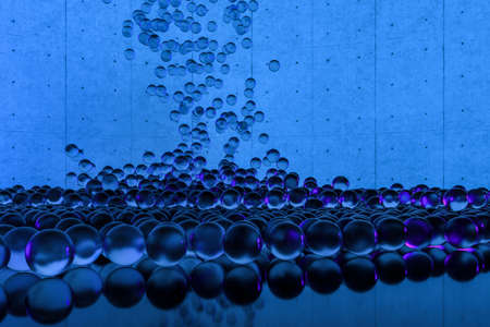 A mass of spheres falling down from above, 3d rendering. Computer digital drawing.の写真素材