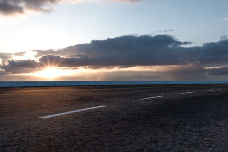 The empty Asphalt road and daylight sky and sunshine. Empty road background.
