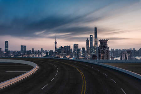 Asphalt road and urban building background, driveway and road. City road background.のeditorial素材