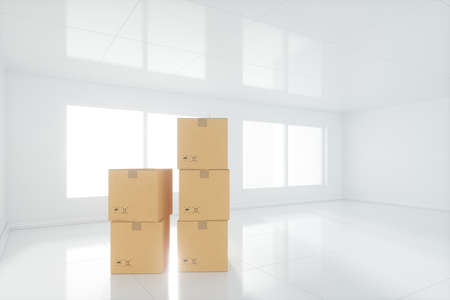 Stacked cardboard in the empty room, with sunlight come from the windows, 3d rendering. Computer...