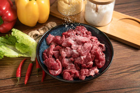 Raw beef with wooden table background, still life photography.