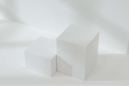 White cubic podium on the floor, 3d rendering. Computer digital drawing.の写真素材