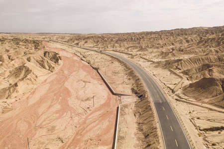 Dryness land with erosion terrain with highway crossing. Photo in western Chinaの写真素材